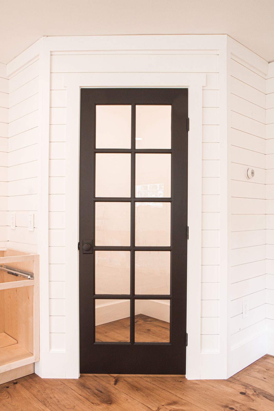 Pantry with black glass door