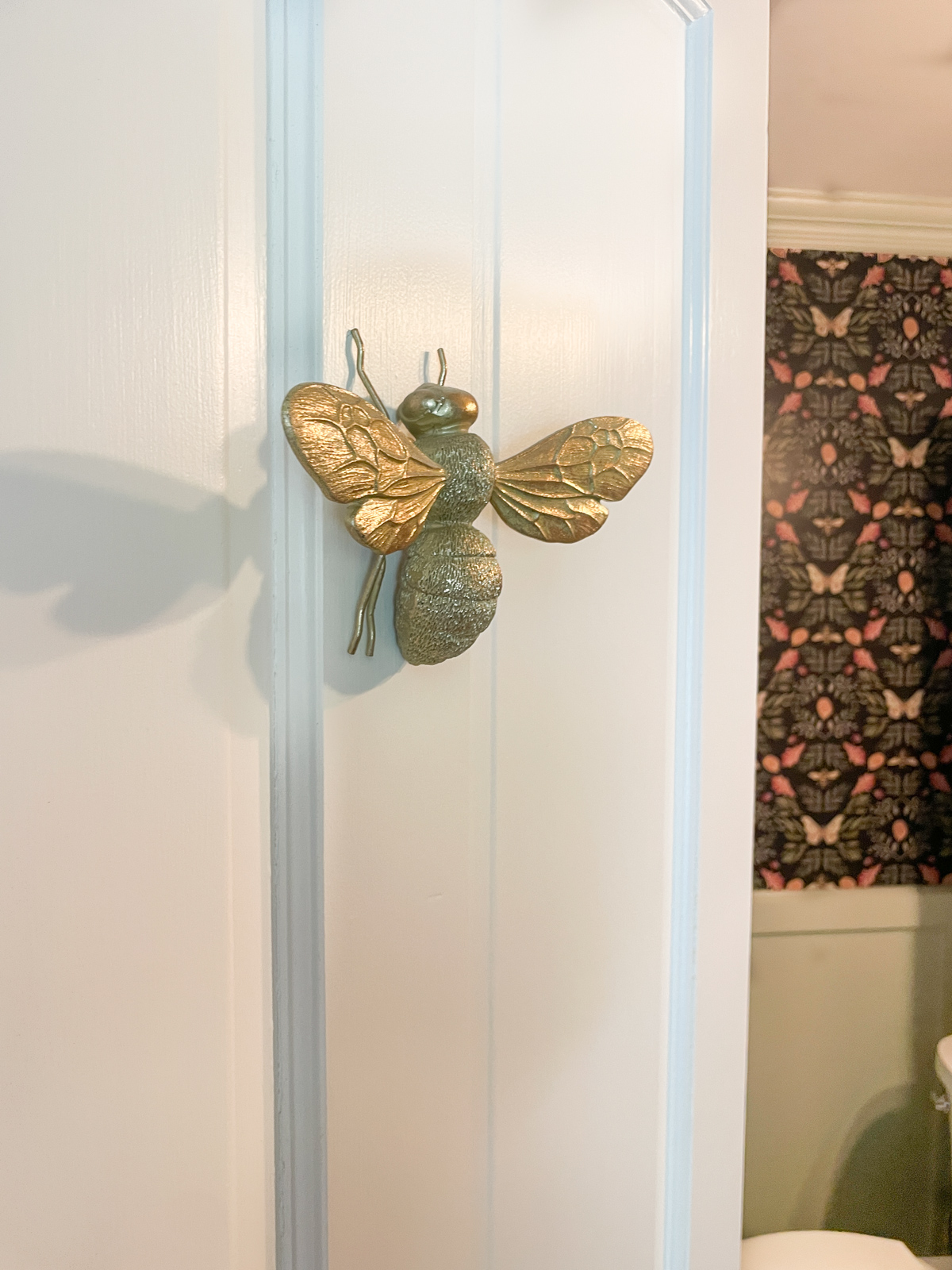 Brass bee decoration on door