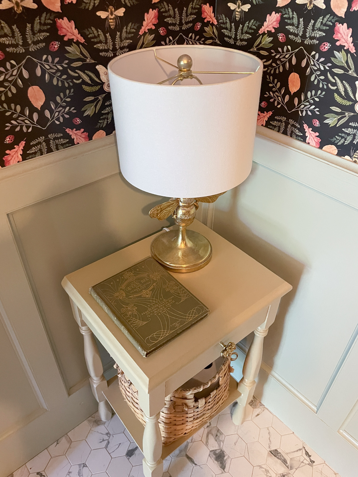 Charming painted side table with bee lamp and vintage book