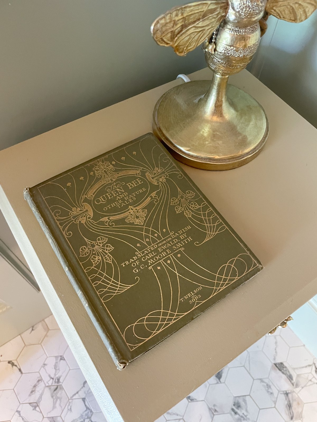 Bee and Butterfly themed bathroom with vintage book on table