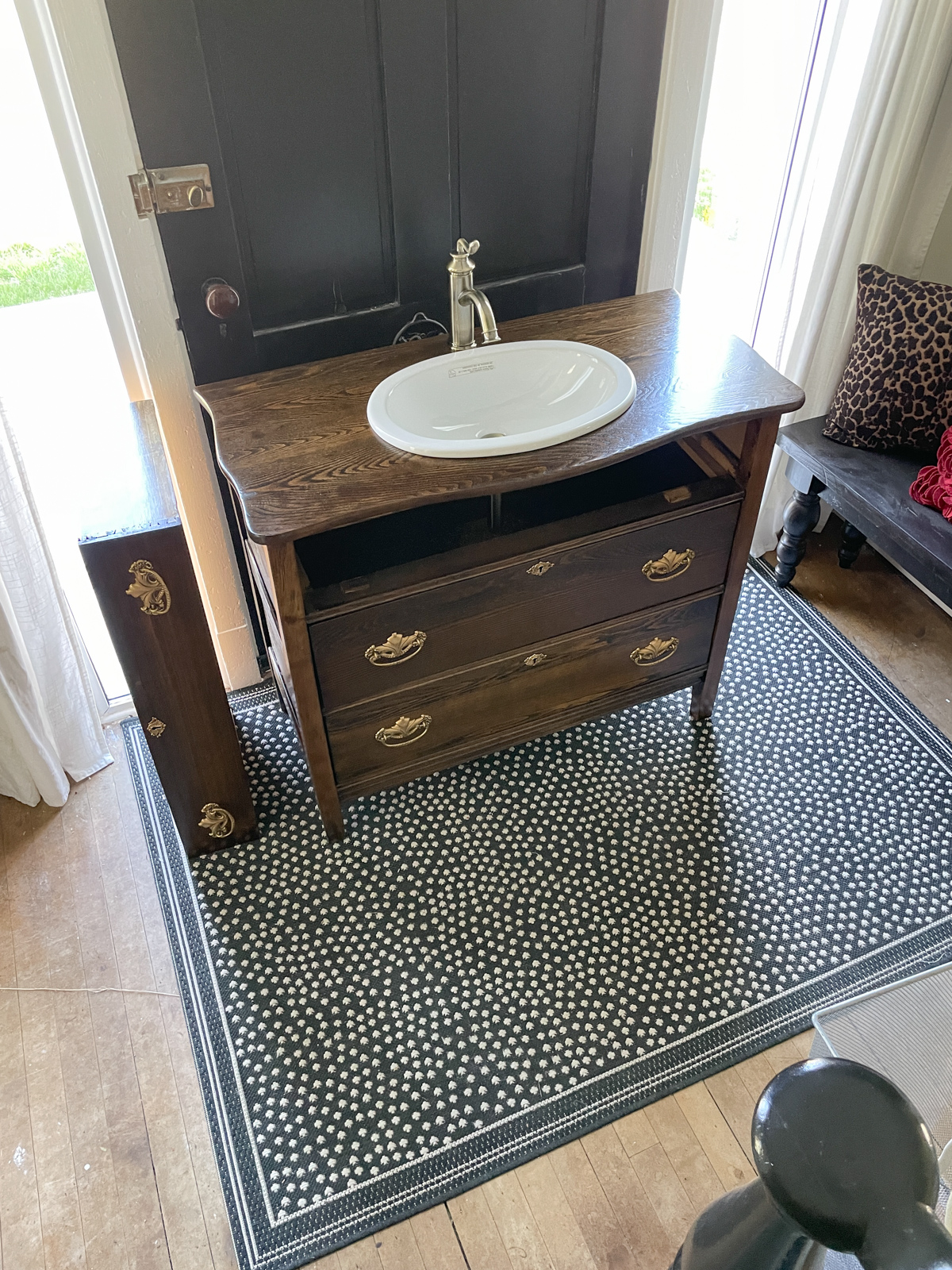 Antique dresser remodeled into a bathroom vanity with an oval sink installed